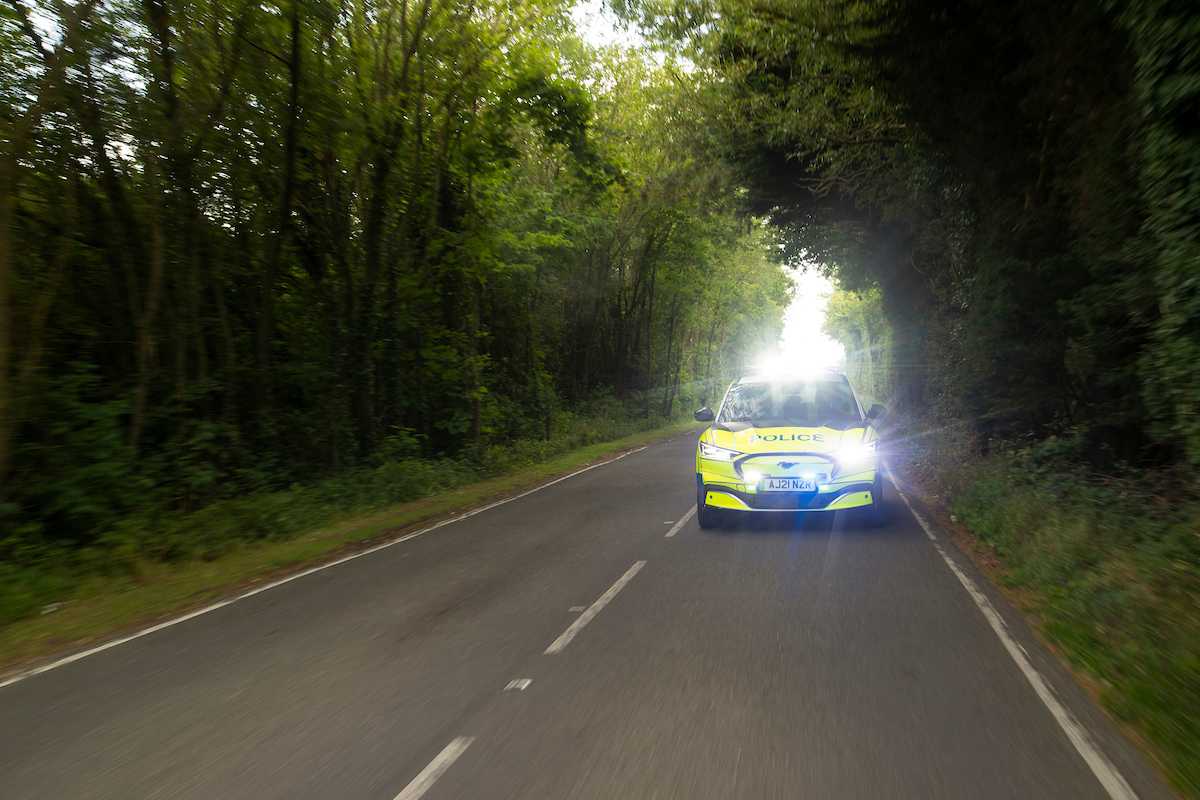 Driver crashes into a police car whilst caught having ‘adult time’ with passenger