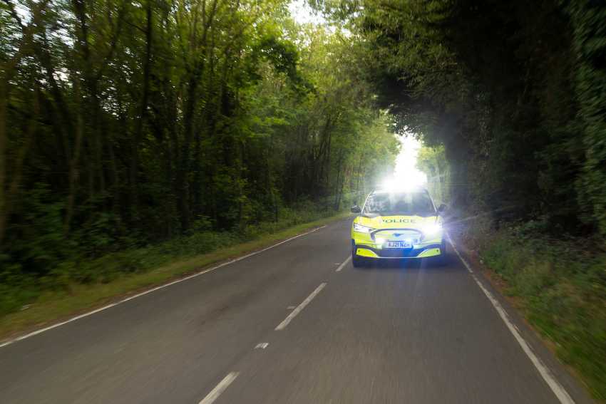 Driver crashes into a police car whilst caught having ‘adult time’ with passenger