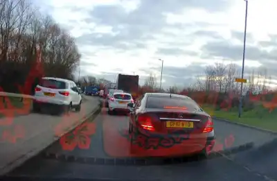 Watch: Impatient driver mounts pavement to dodge traffic