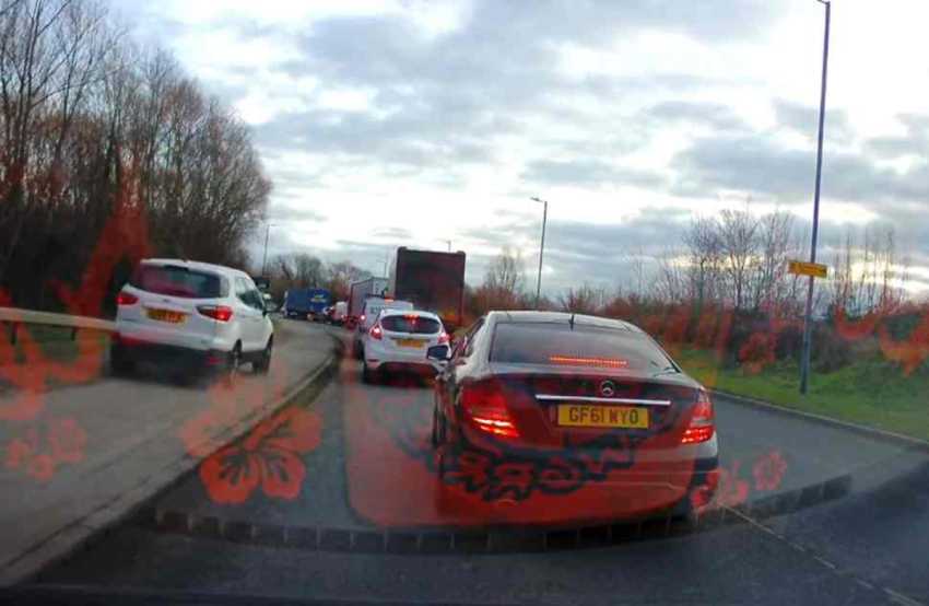 Watch: Impatient driver mounts pavement to dodge traffic