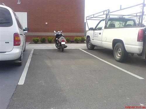Car park full - you pull in to what you think is a space to find a motorcycle/moped hidden between two cars 